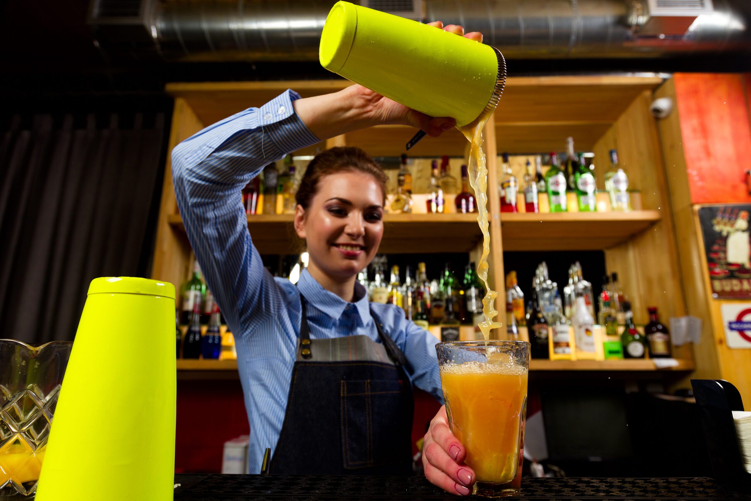 The bartender prepares cocktails at the bar