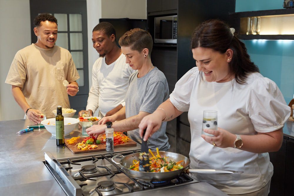 Diverse group of people cooking together in a kitchen