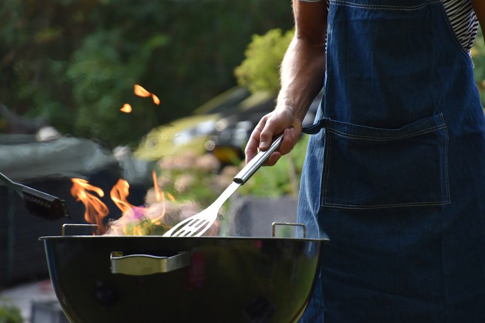 Man grilling outdoors on a BBQ in summer