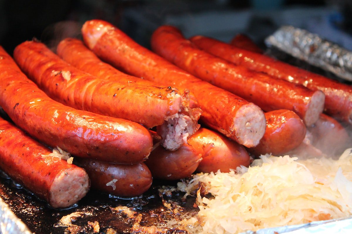 German bratwurst sausages on a grill with sauerkraut