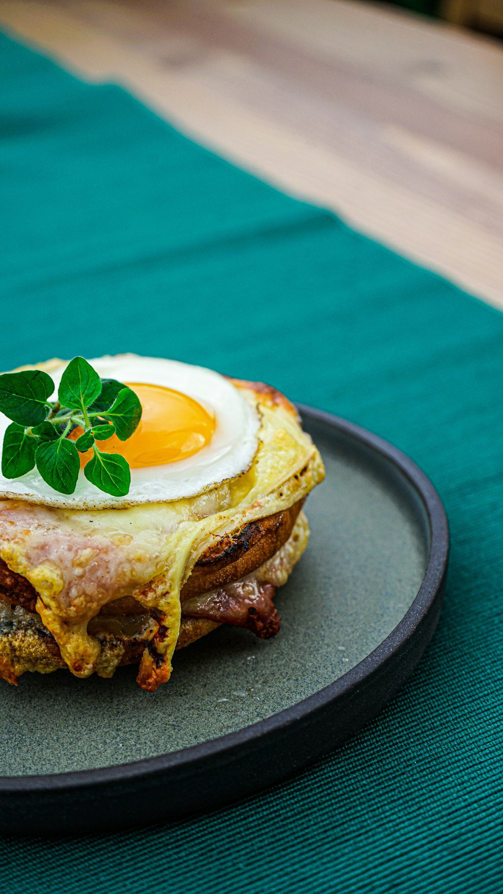 Eggs benedict brunch dish on a dark plate