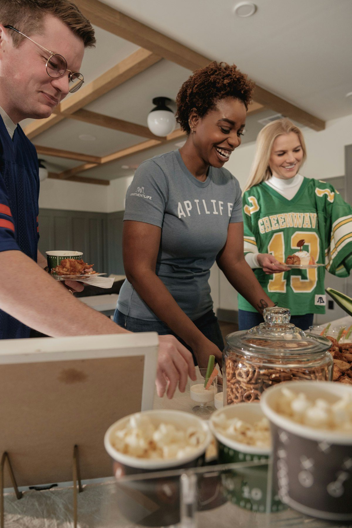 Team gathering around a food buffet at a summer team building event